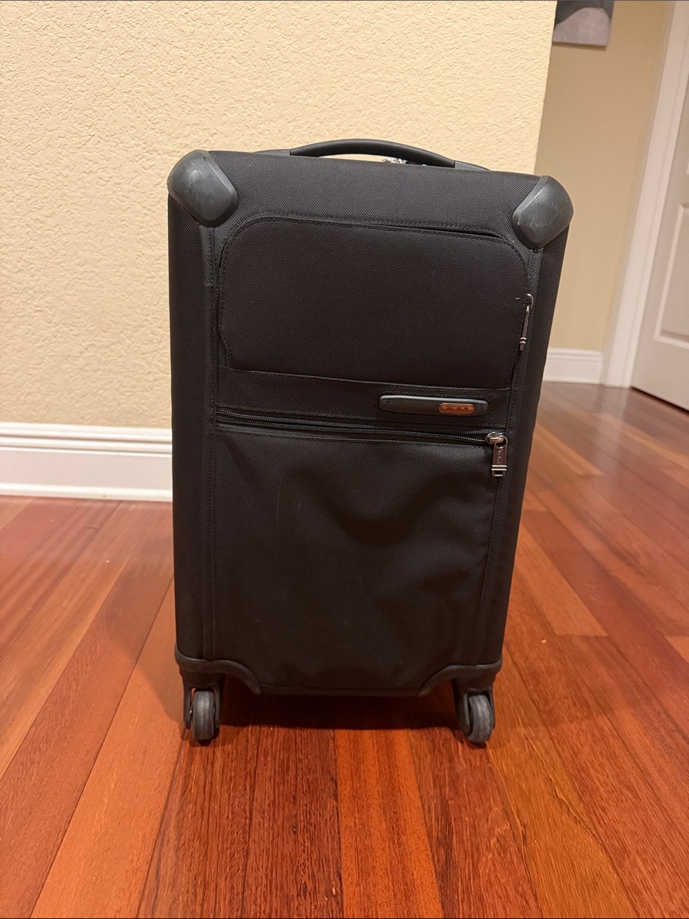 Tumi Black Carry-On Spinner with Front Zip Pocket